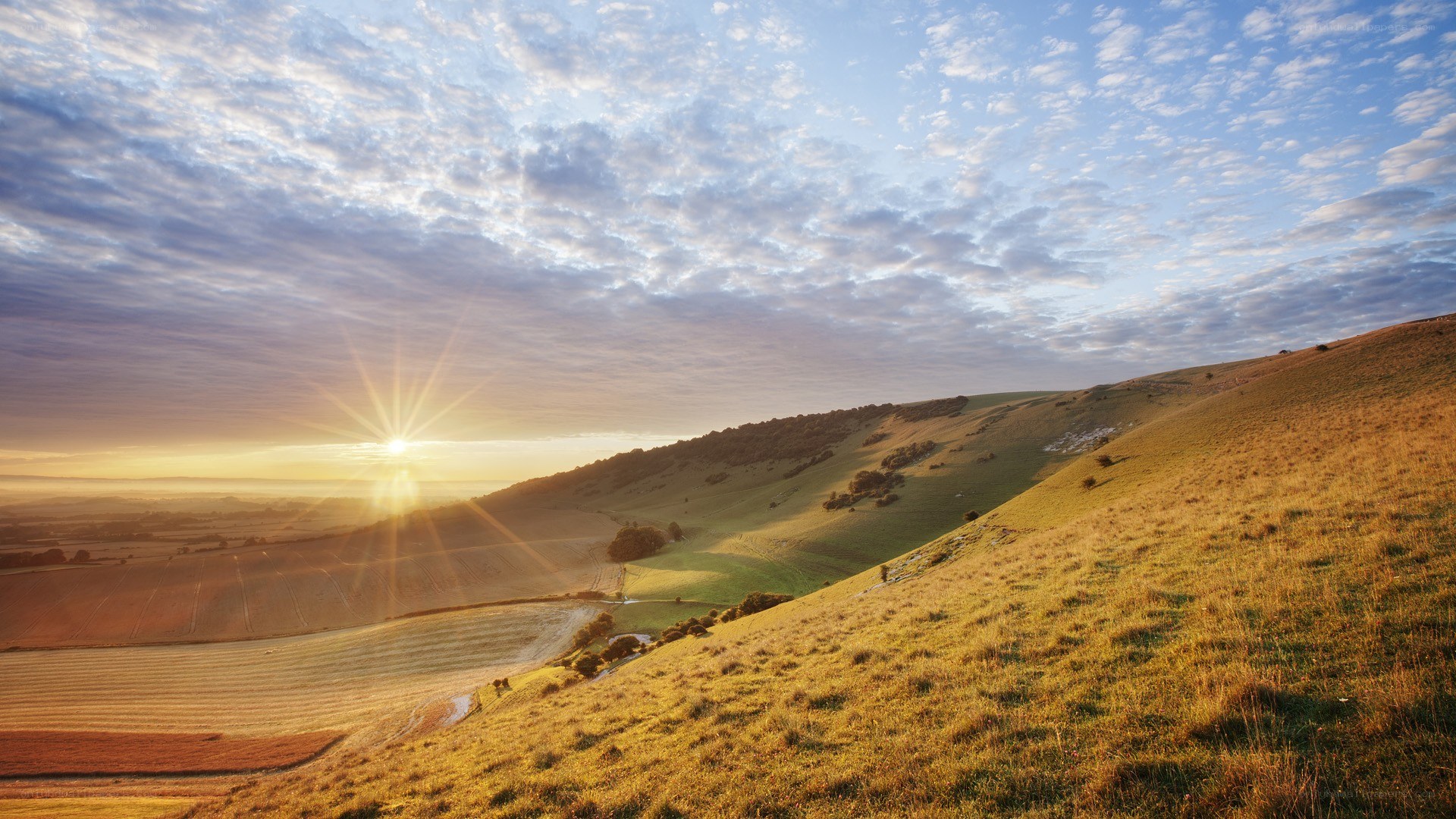 Sunrise over rolling hills