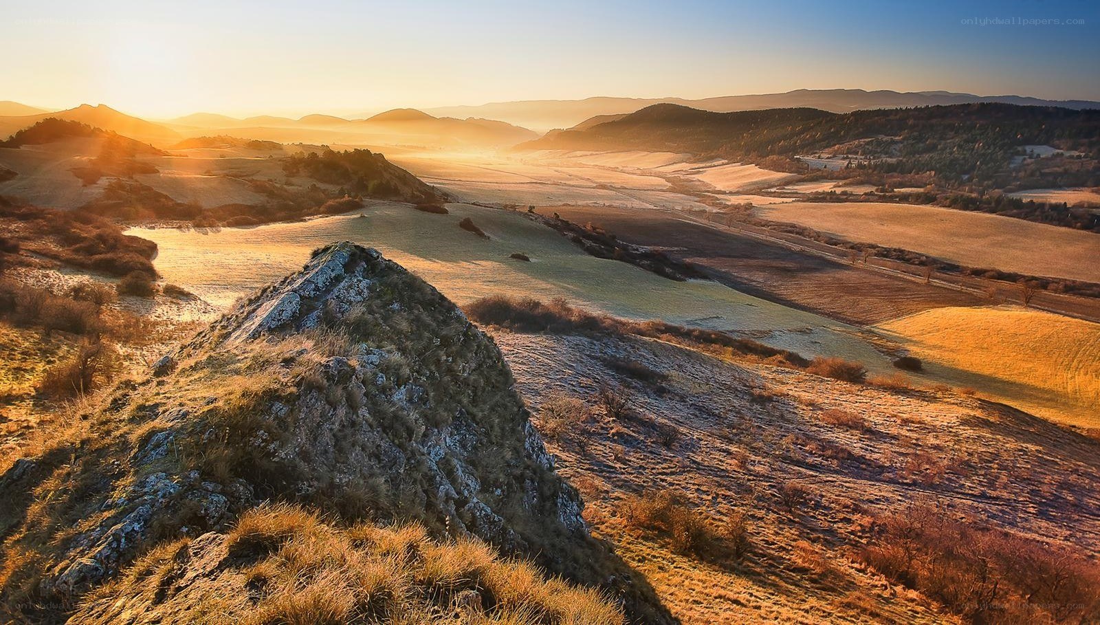Sunrise over rolling hills