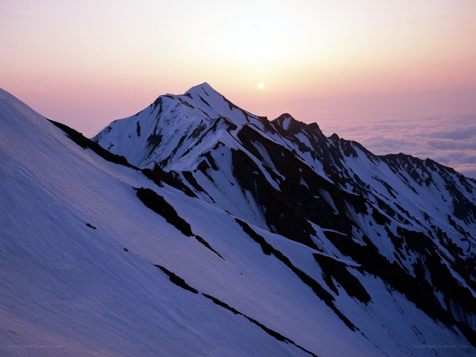 Sunrise over snow-capped mountains