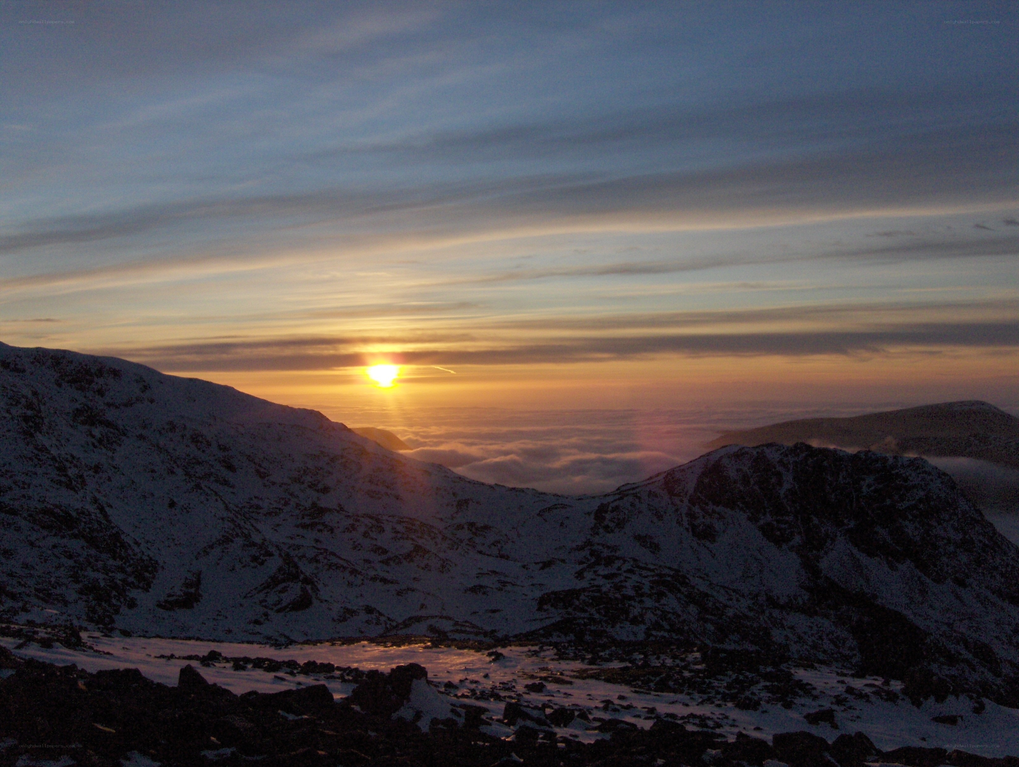 Sunrise over snow-covered mountains