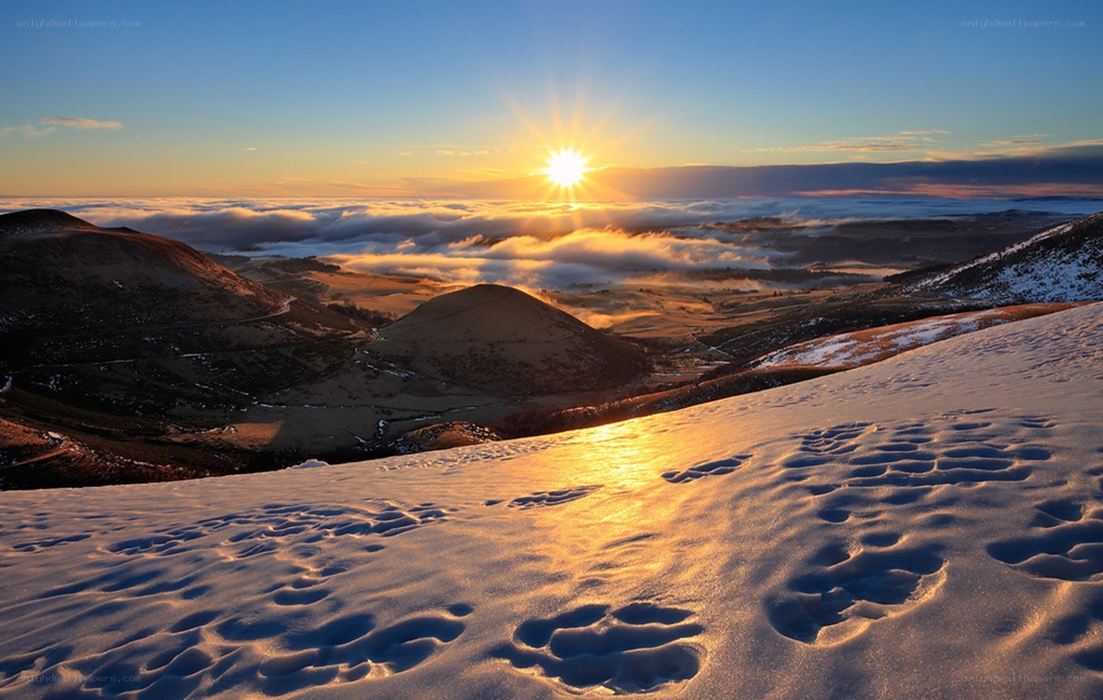 Sunrise over snowy hills