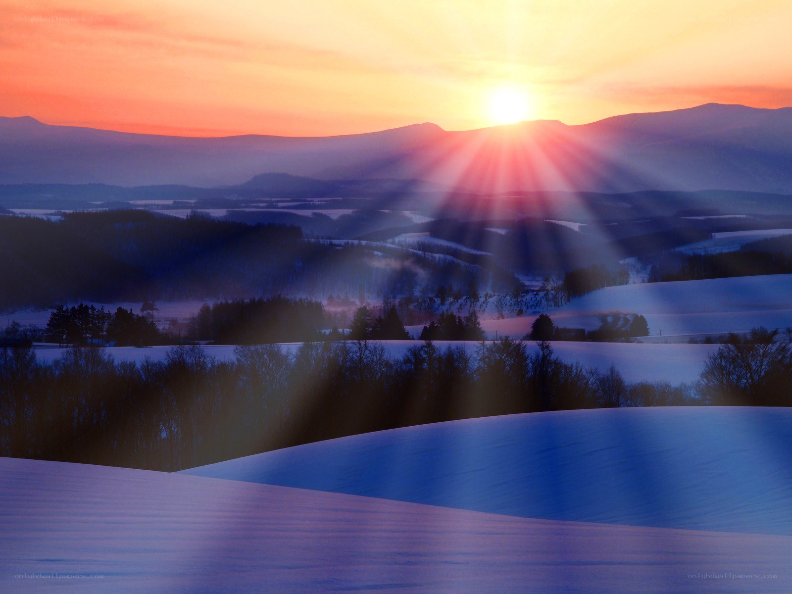 Sunrise over snowy hills