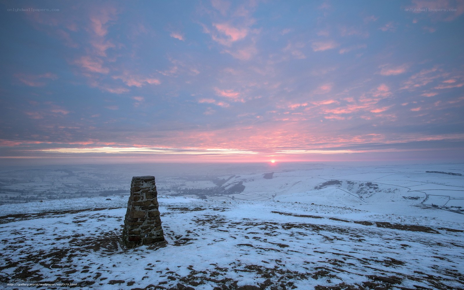 Sunrise over snowy hilltop