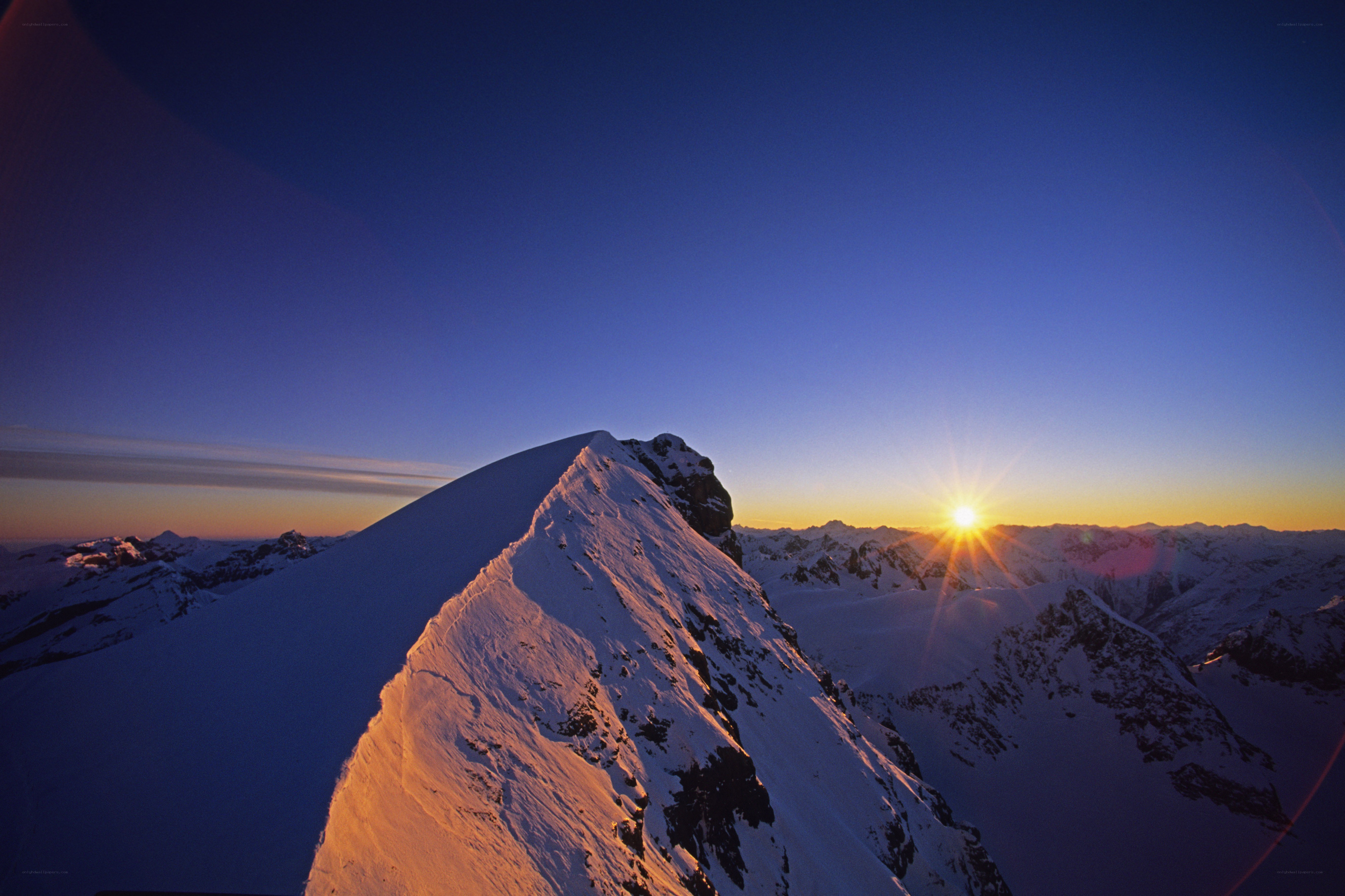 Sunrise over snowy mountain peak
