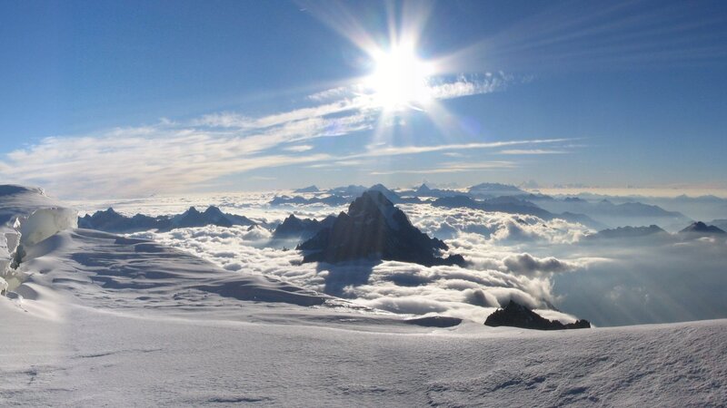 Sunrise over snowy mountain peaks
