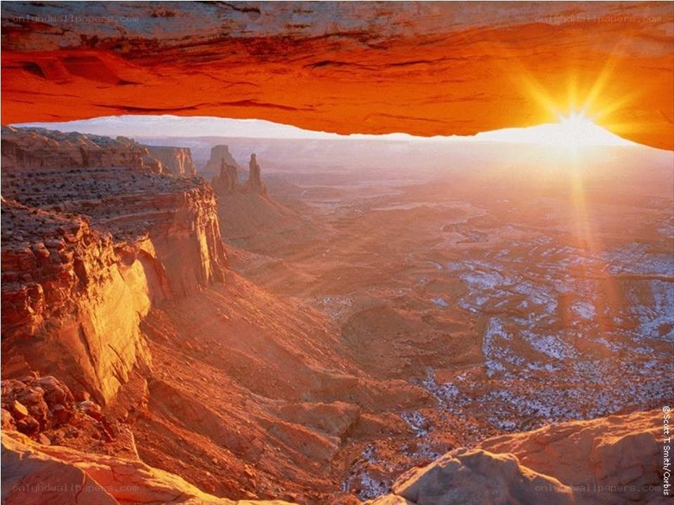 Sunrise through natural arch
