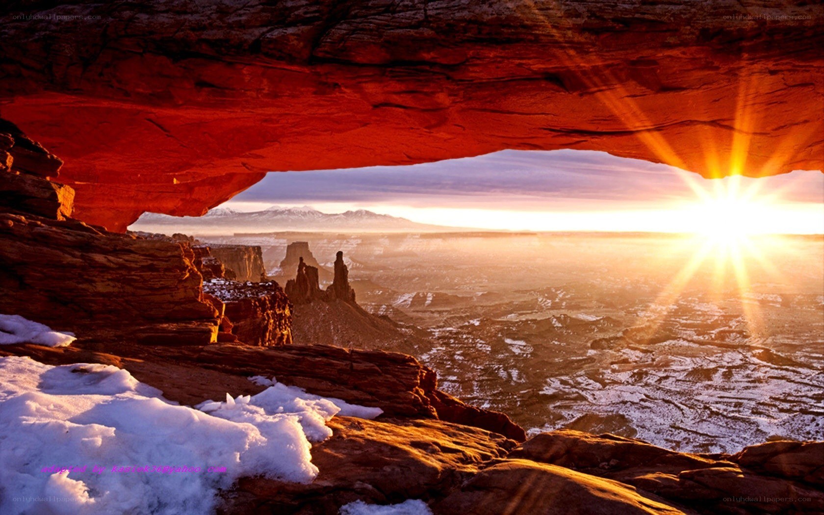 Sunrise through natural arch
