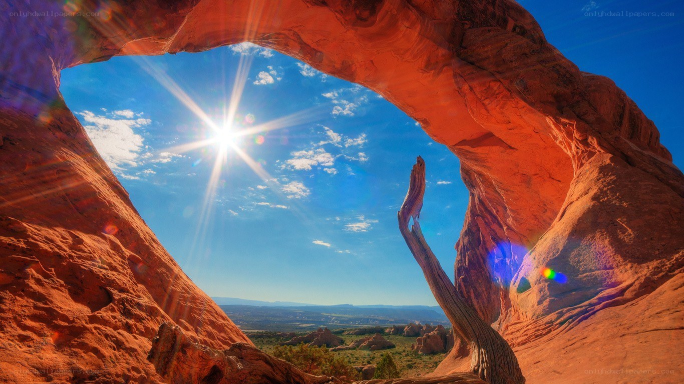 Sunrise through natural arch