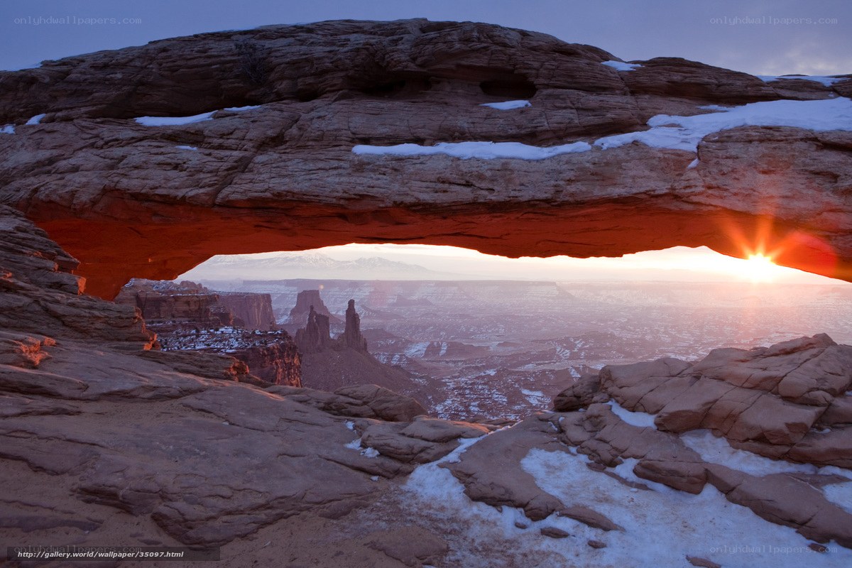 Sunrise through natural arch