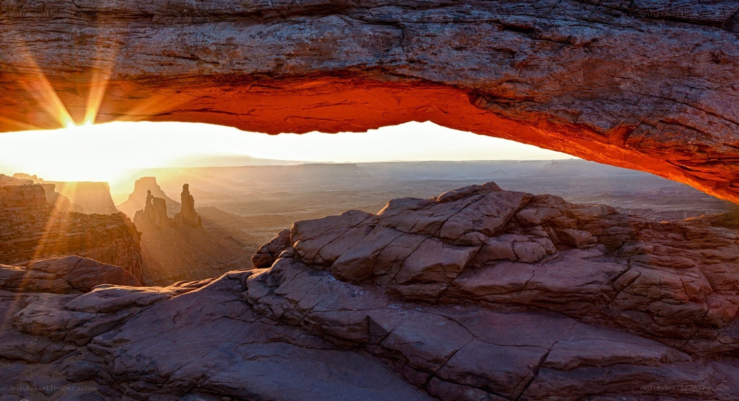 Sunrise through natural rock arch