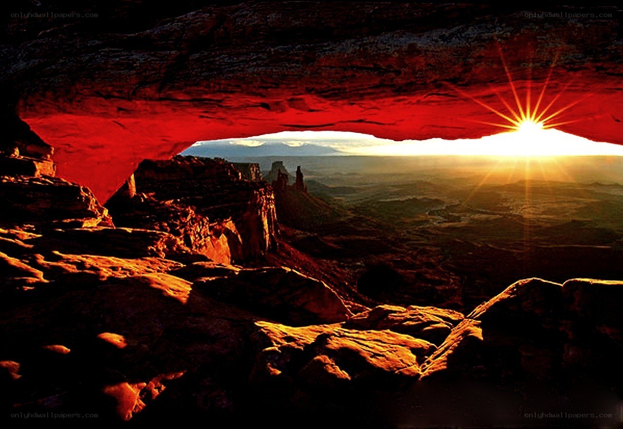 Sunrise through natural rock arch