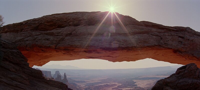 Sunrise through natural rock arch