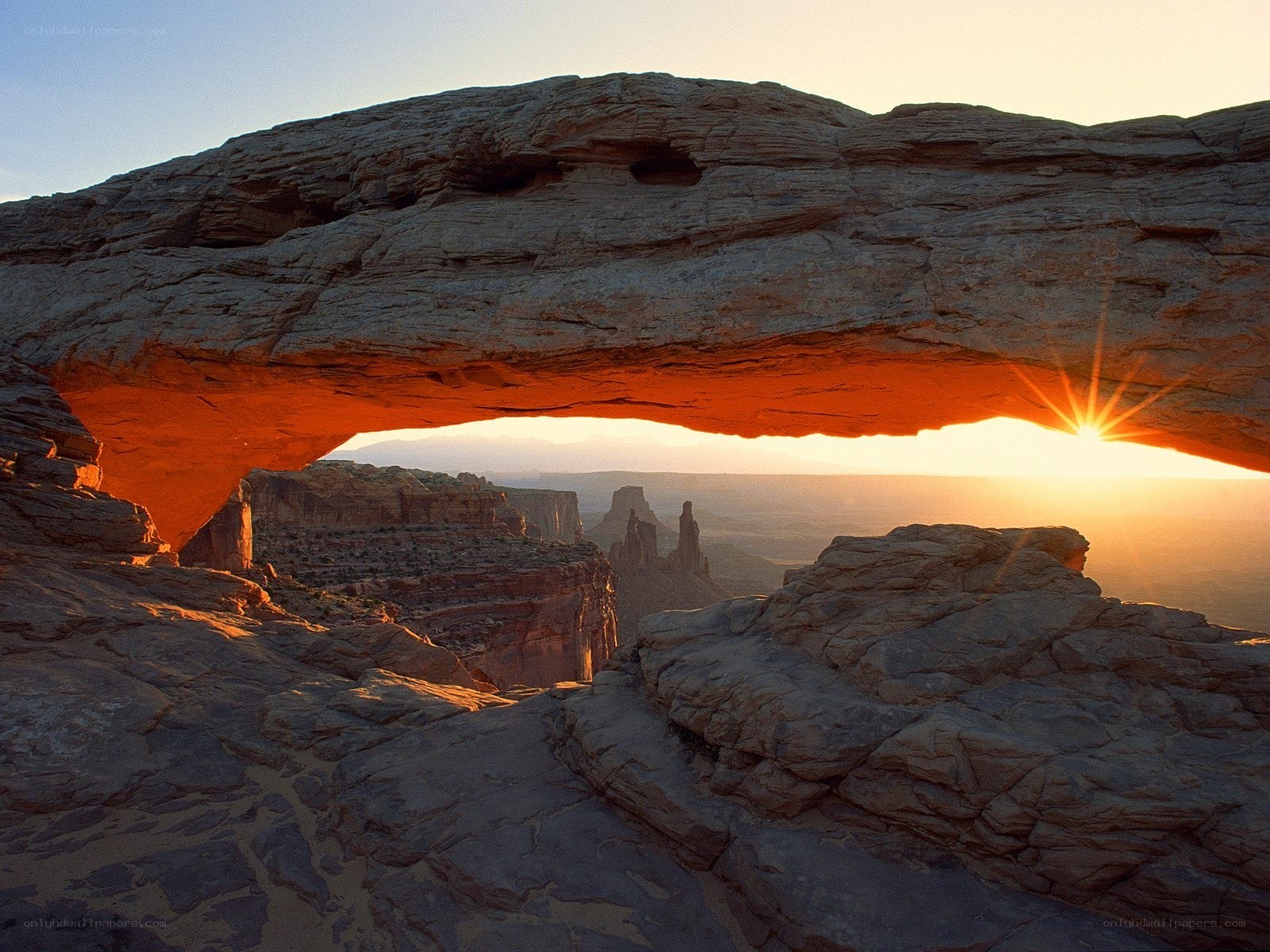 Sunrise through natural rock arch