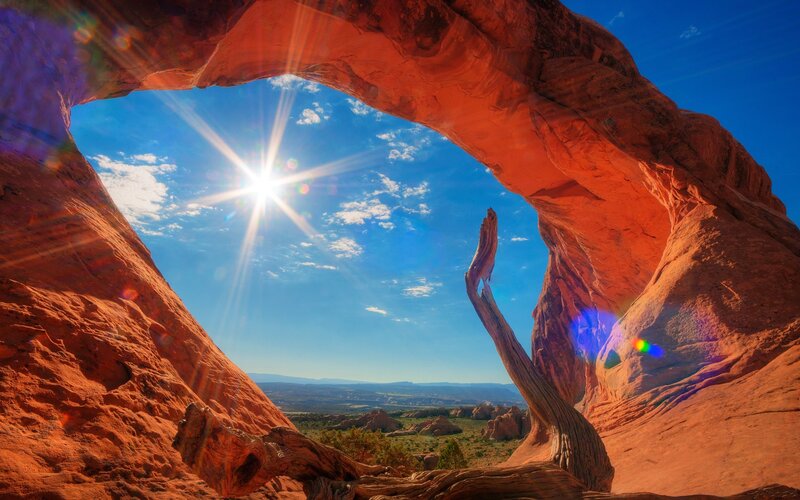 Sunrise through natural rock arch