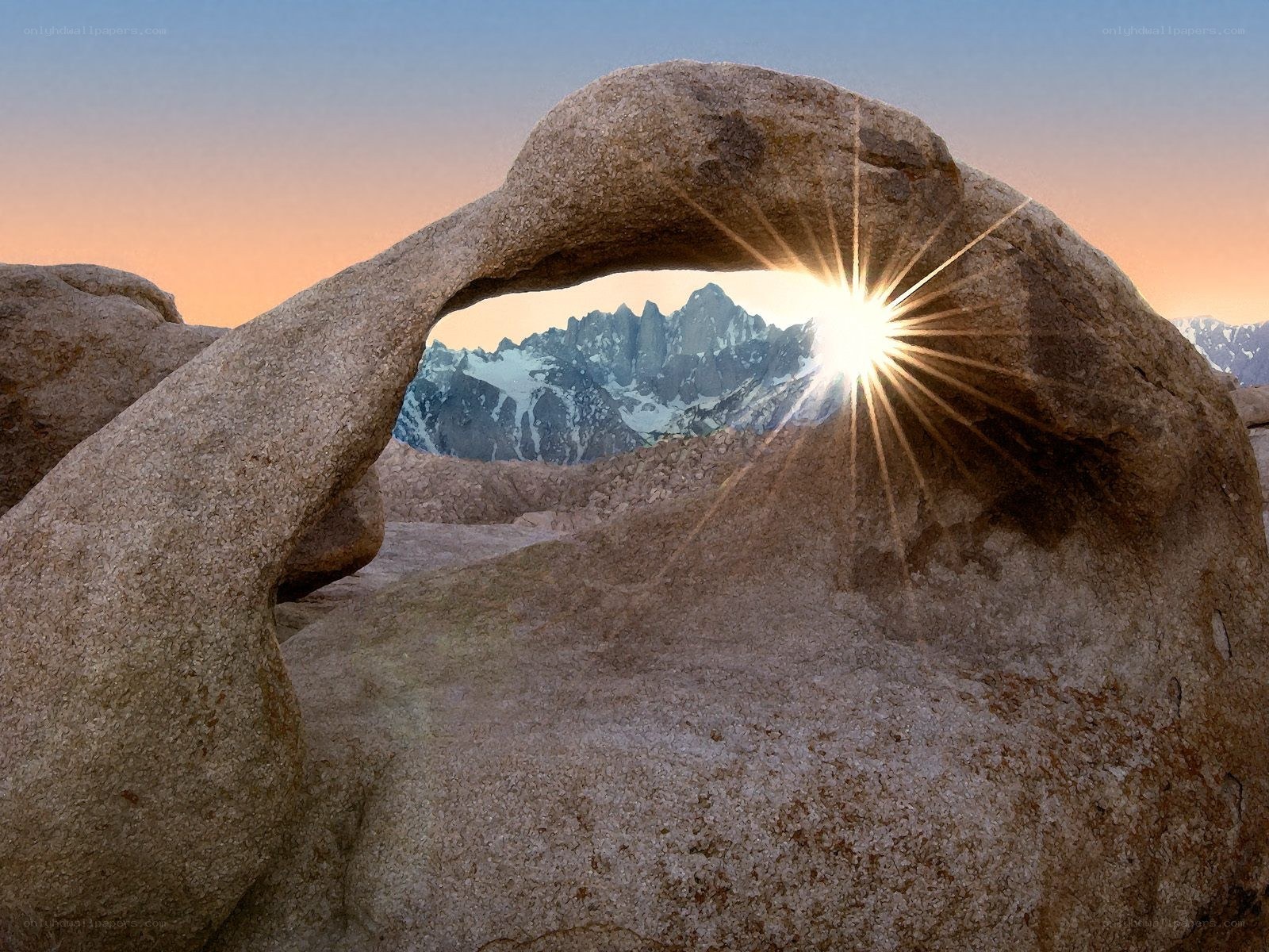 Sunrise through natural rock arch