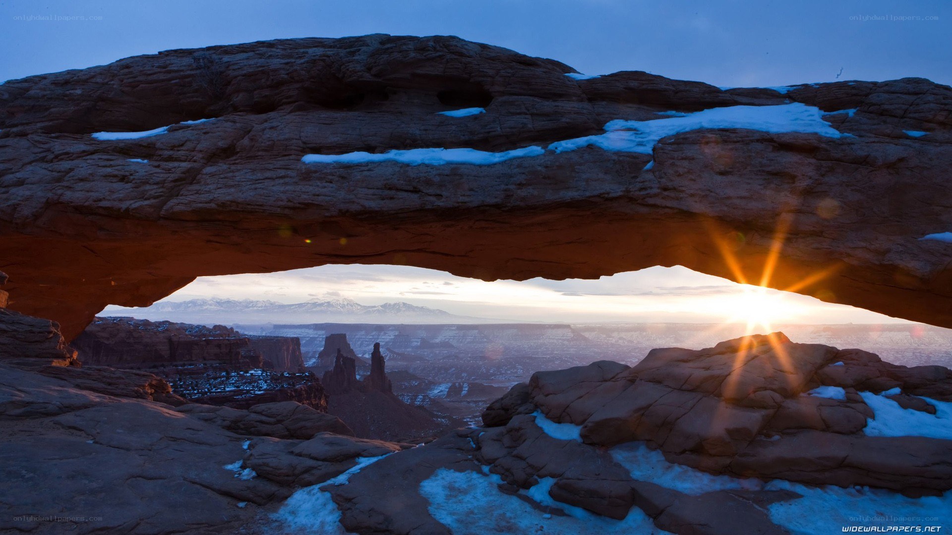 Sunrise through natural rock arch