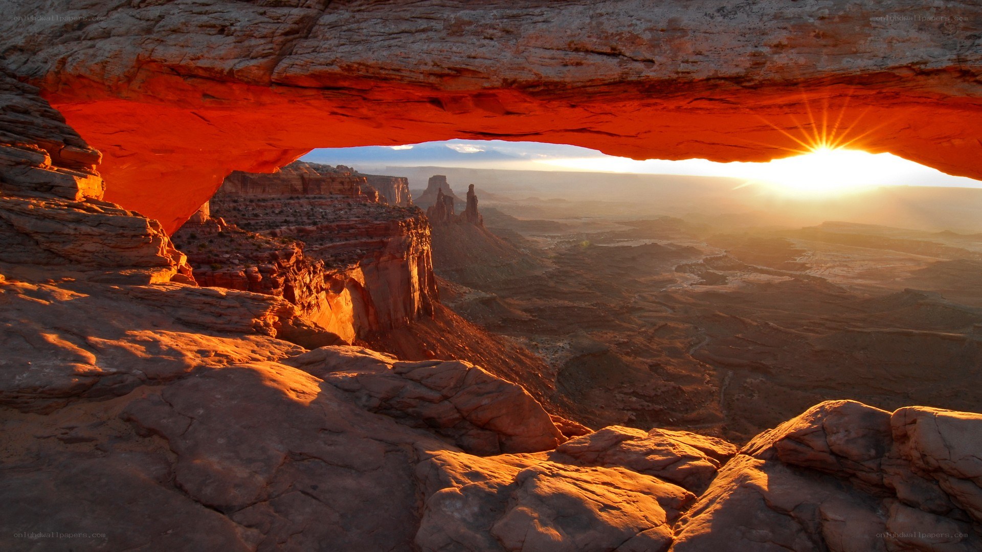 Sunrise through natural rock arch
