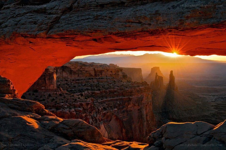 Sunrise through natural rock arch
