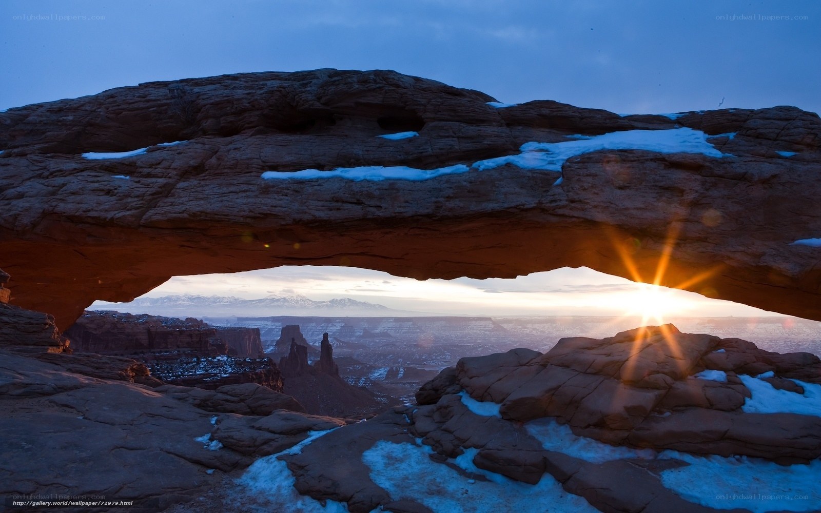 Sunrise through natural rock arch