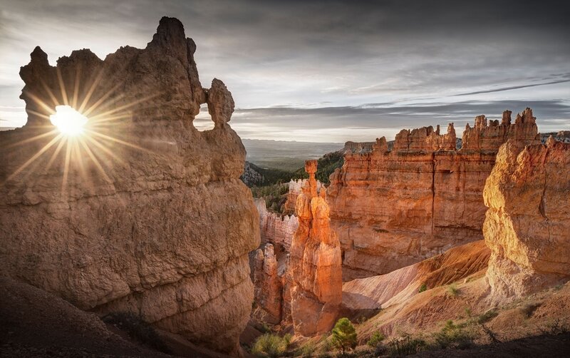 Sunrise Through Rock Formation — Orange, Dramatic