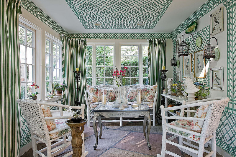 Sunroom with green and white decor