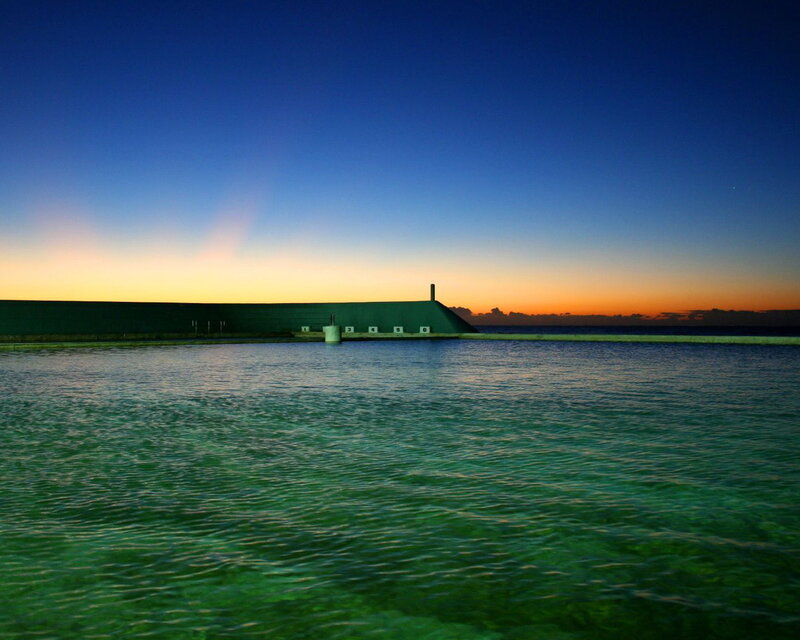 sunset at a coastal pool