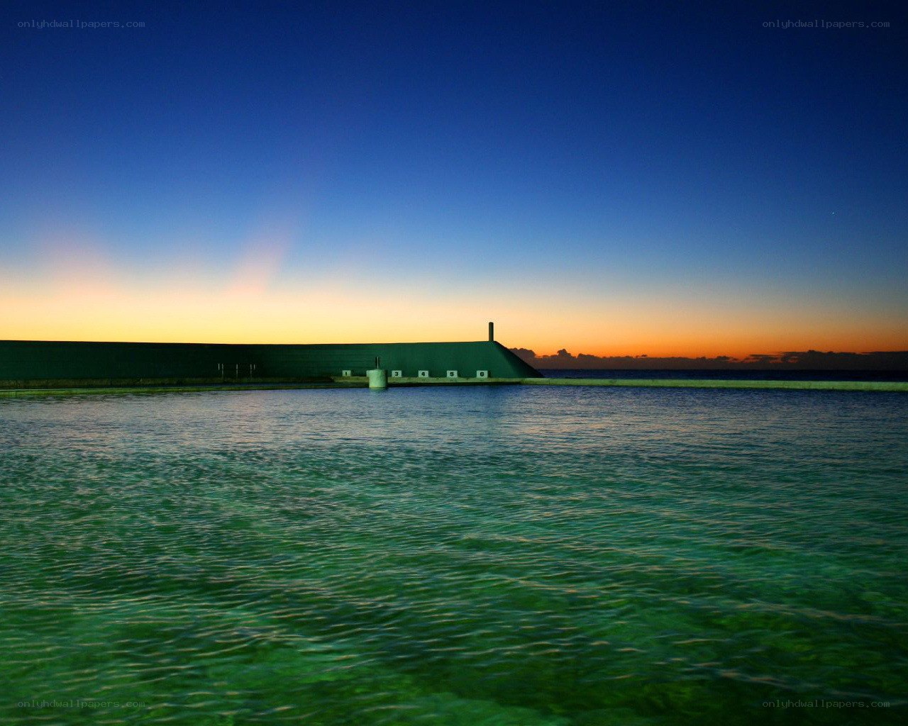 sunset at a coastal pool