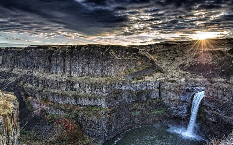 Sunset at a dramatic waterfall canyon