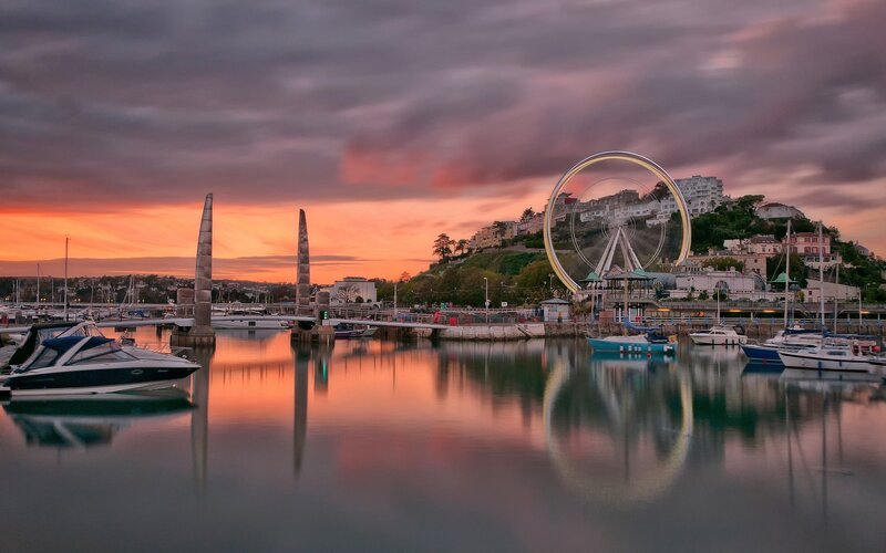 Sunset at a harbor with Ferris wheel