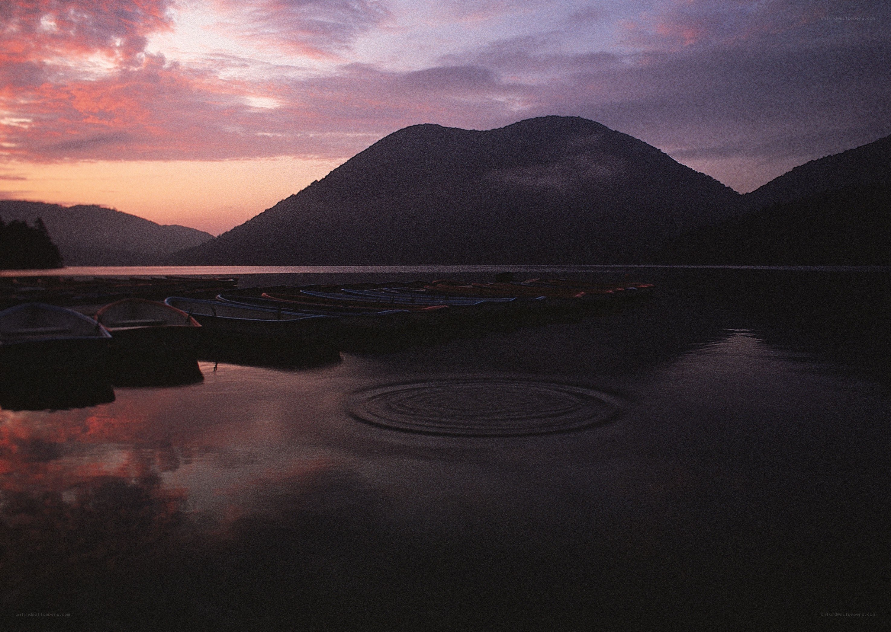 Sunset at a lake with boats