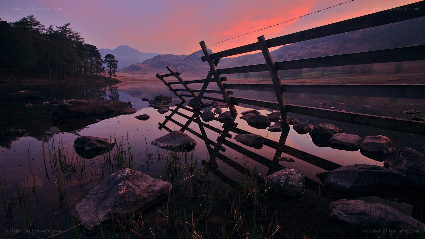 Sunset at a lakeside fence