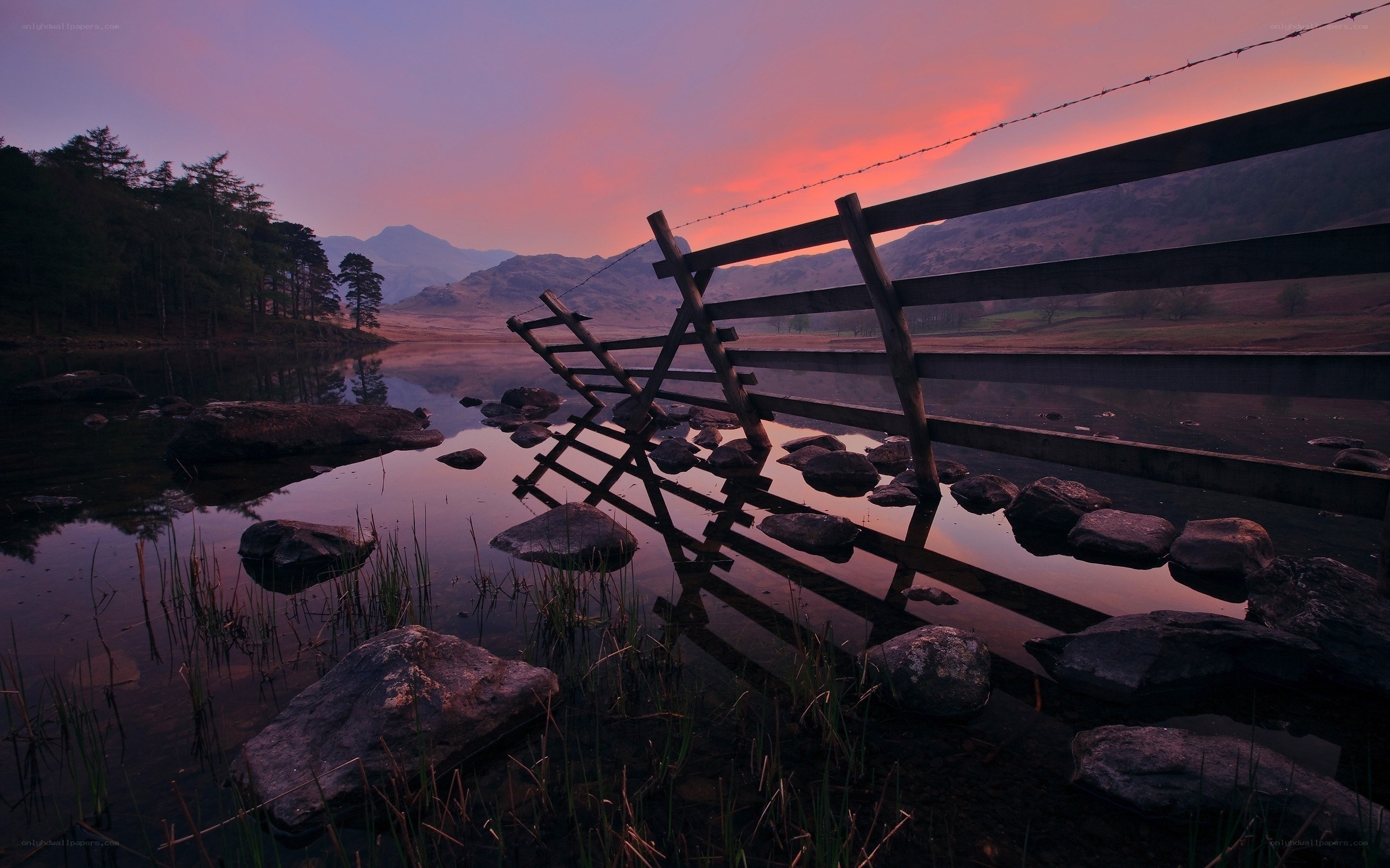 Sunset at a lakeside fence