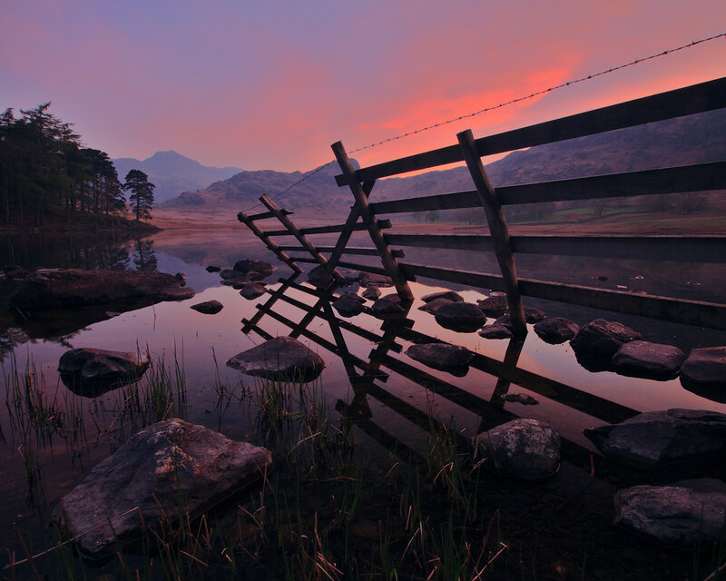 Sunset at a lakeside fence