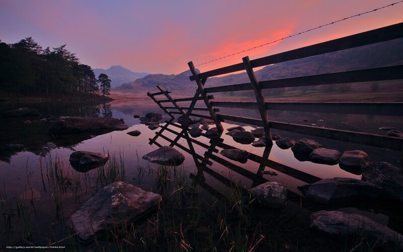 Sunset at a lakeside fence