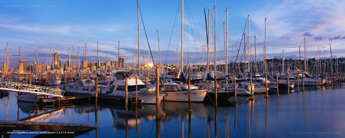Sunset at a marina with city skyline