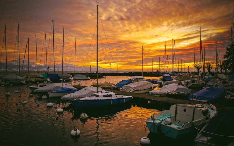 Sunset at a marina with sailboats