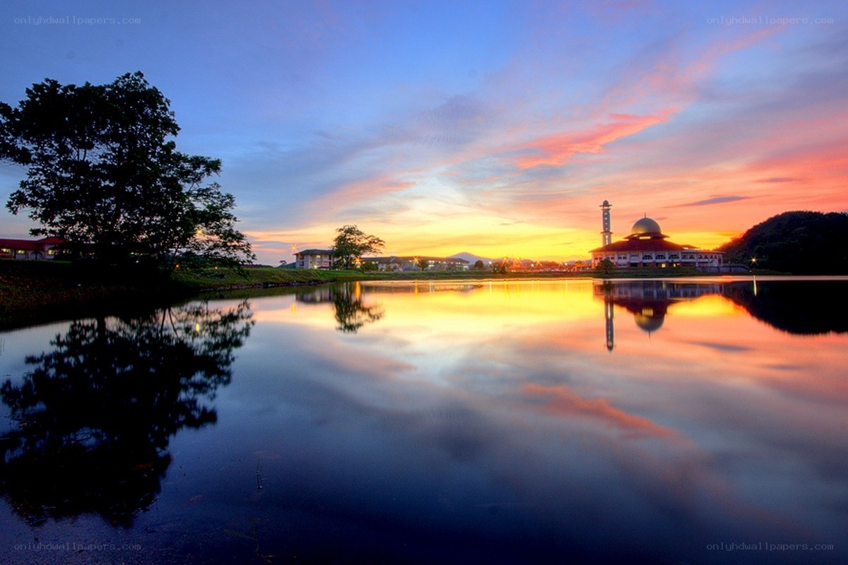 Sunset at a mosque by the lake
