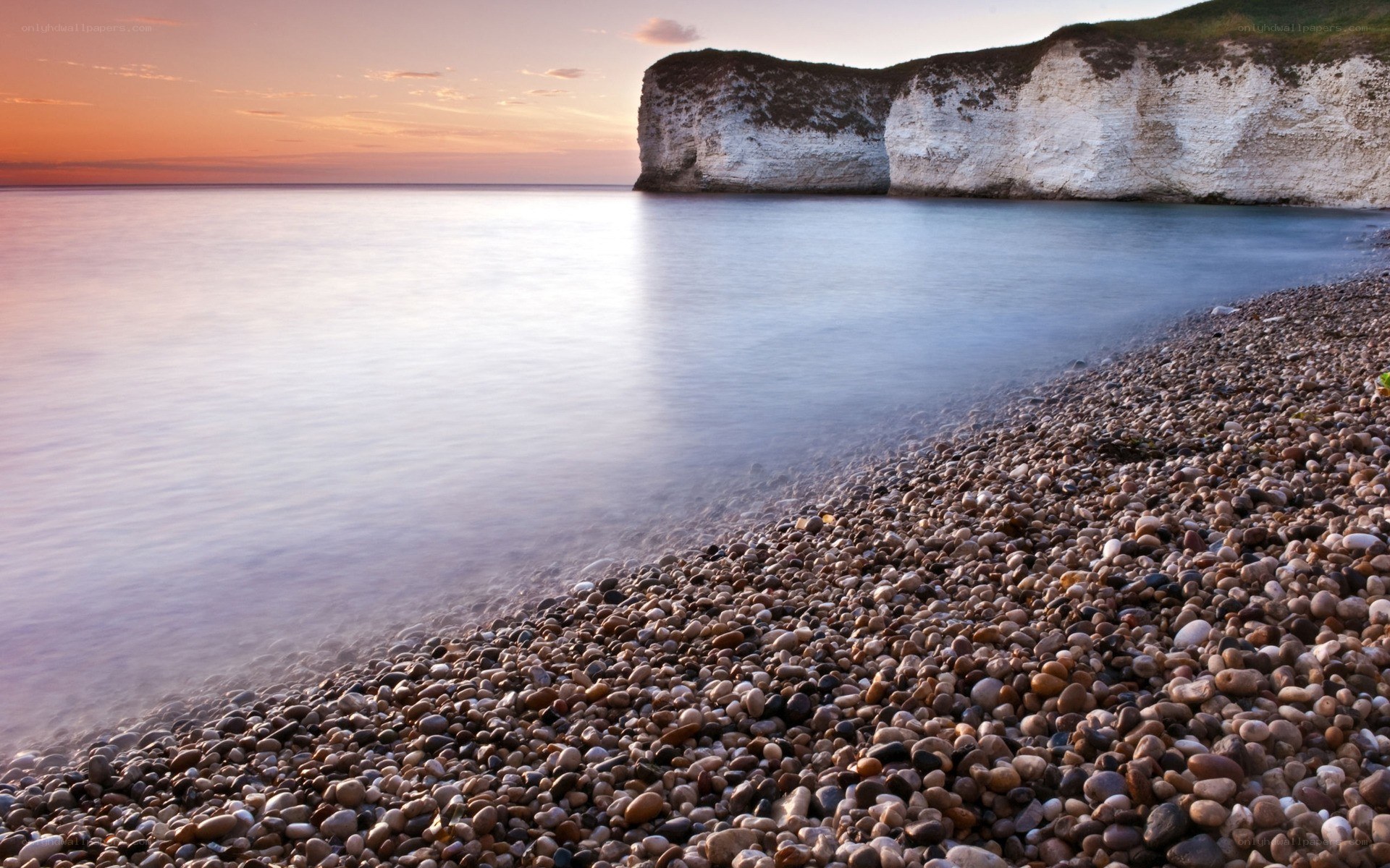 Sunset at a pebble beach
