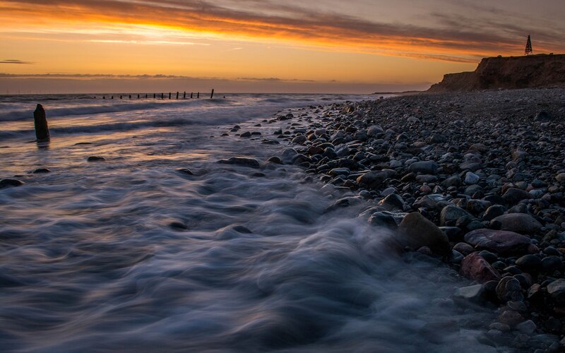 Sunset at a pebble beach