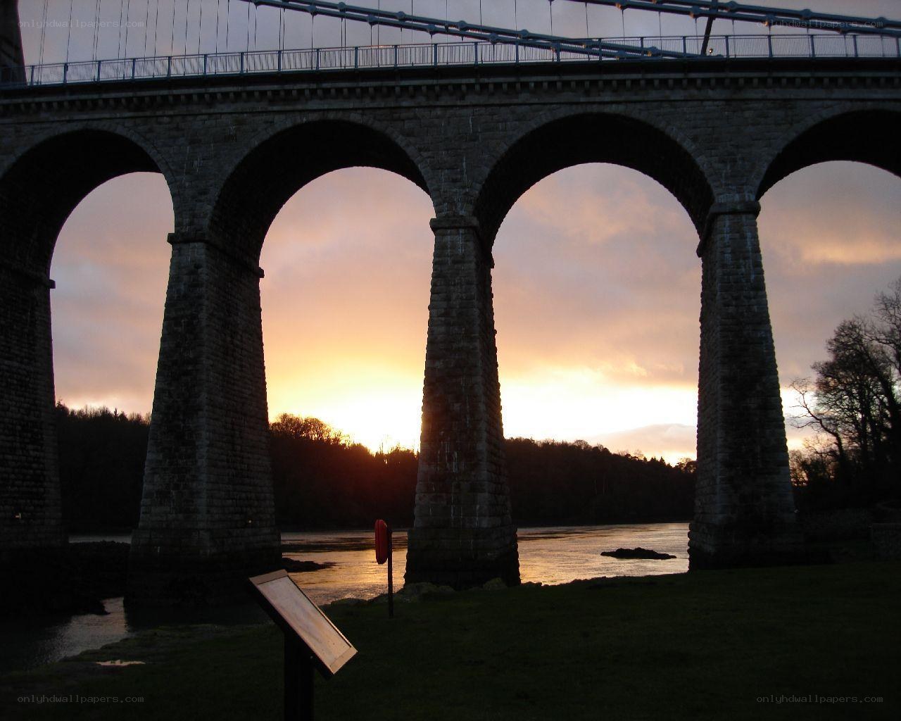 Sunset at a stone arch bridge