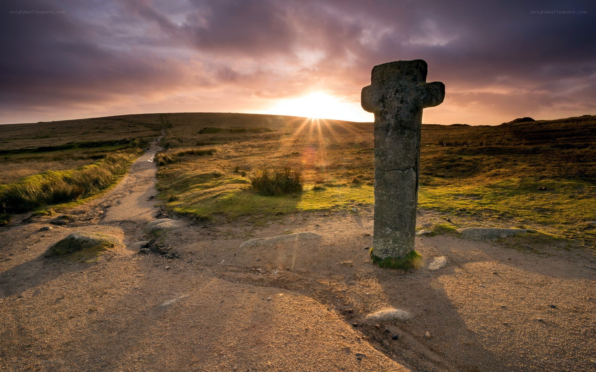 Sunset at a stone cross