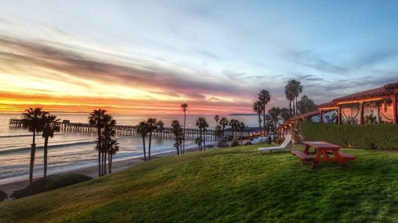 Sunset at Beach Pier — Orange, Serene, Photograph, Palm Trees