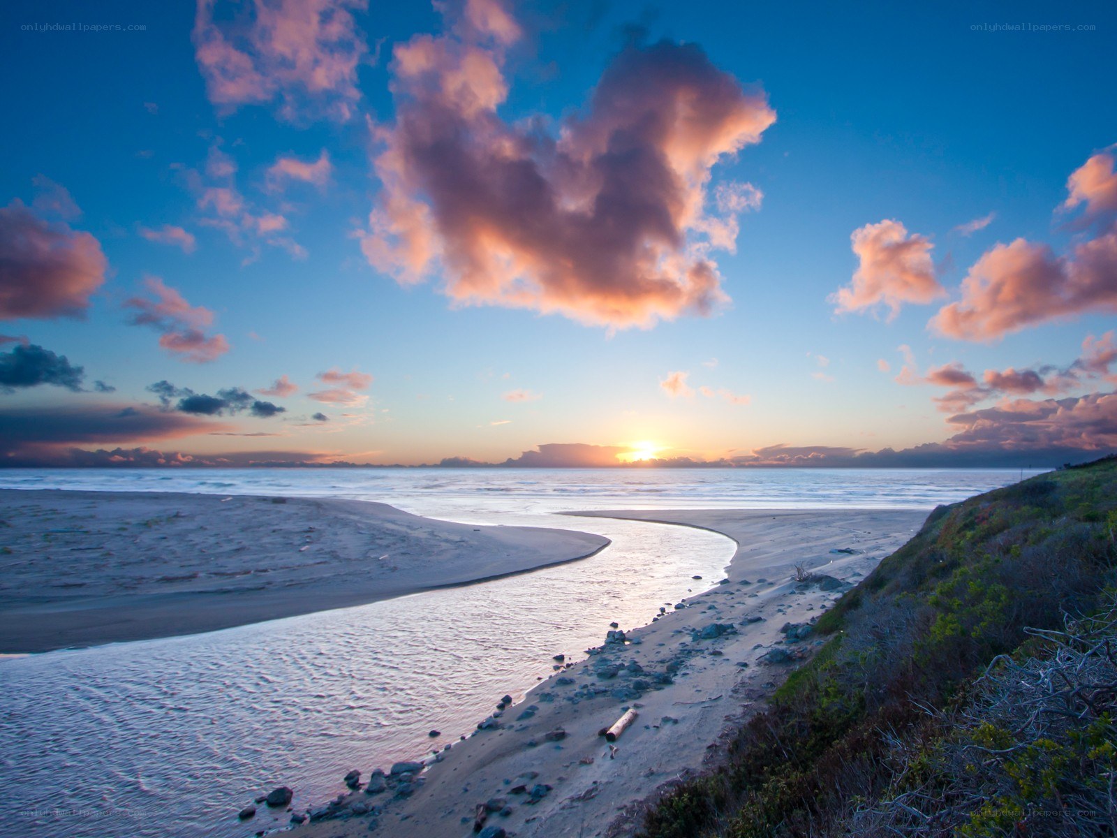 Sunset at coastal river mouth