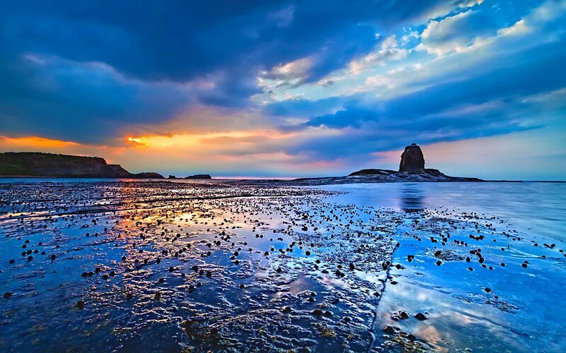 Sunset at coastal rock formation
