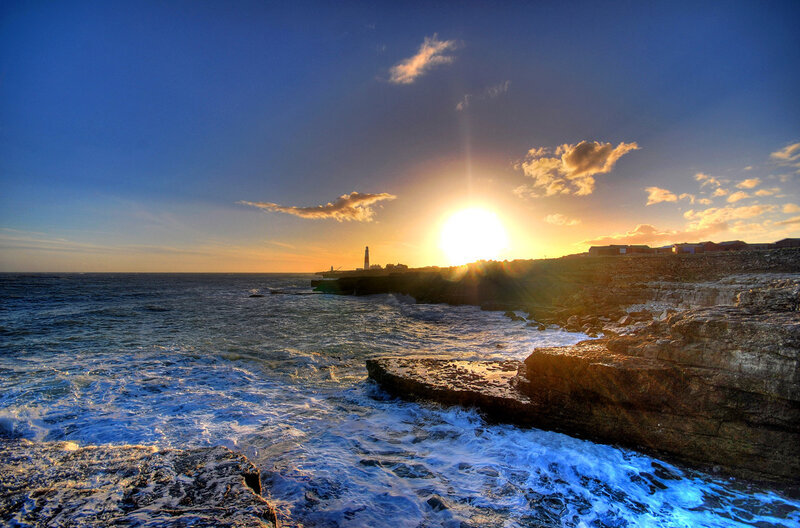 Sunset at lighthouse coast