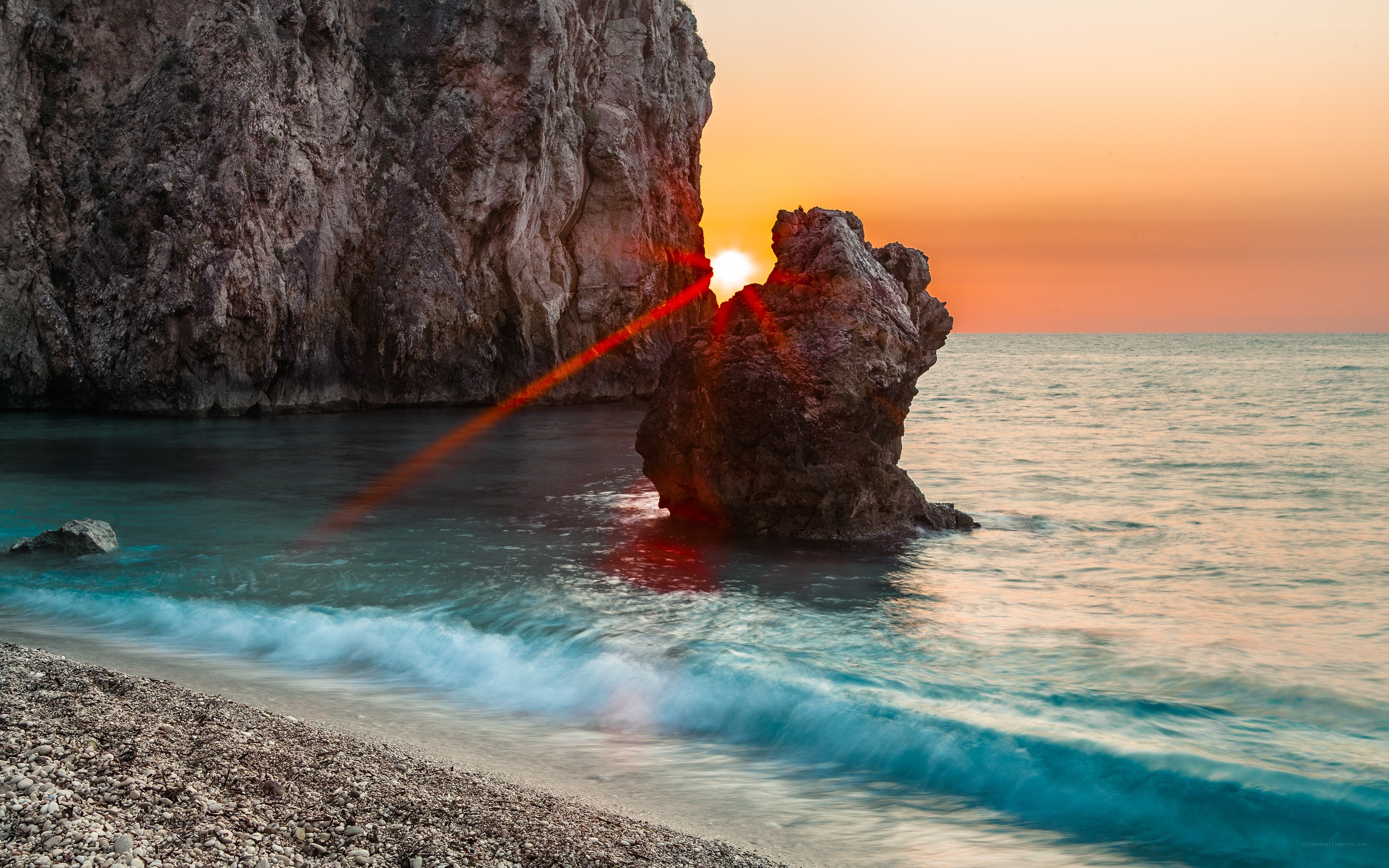 Sunset at rocky beach