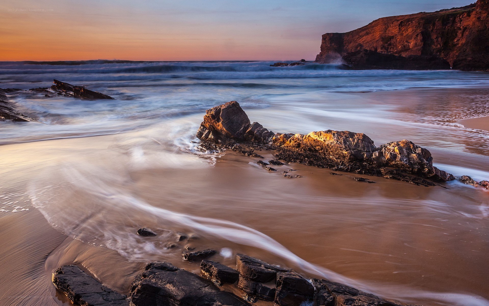 Sunset at rocky beach