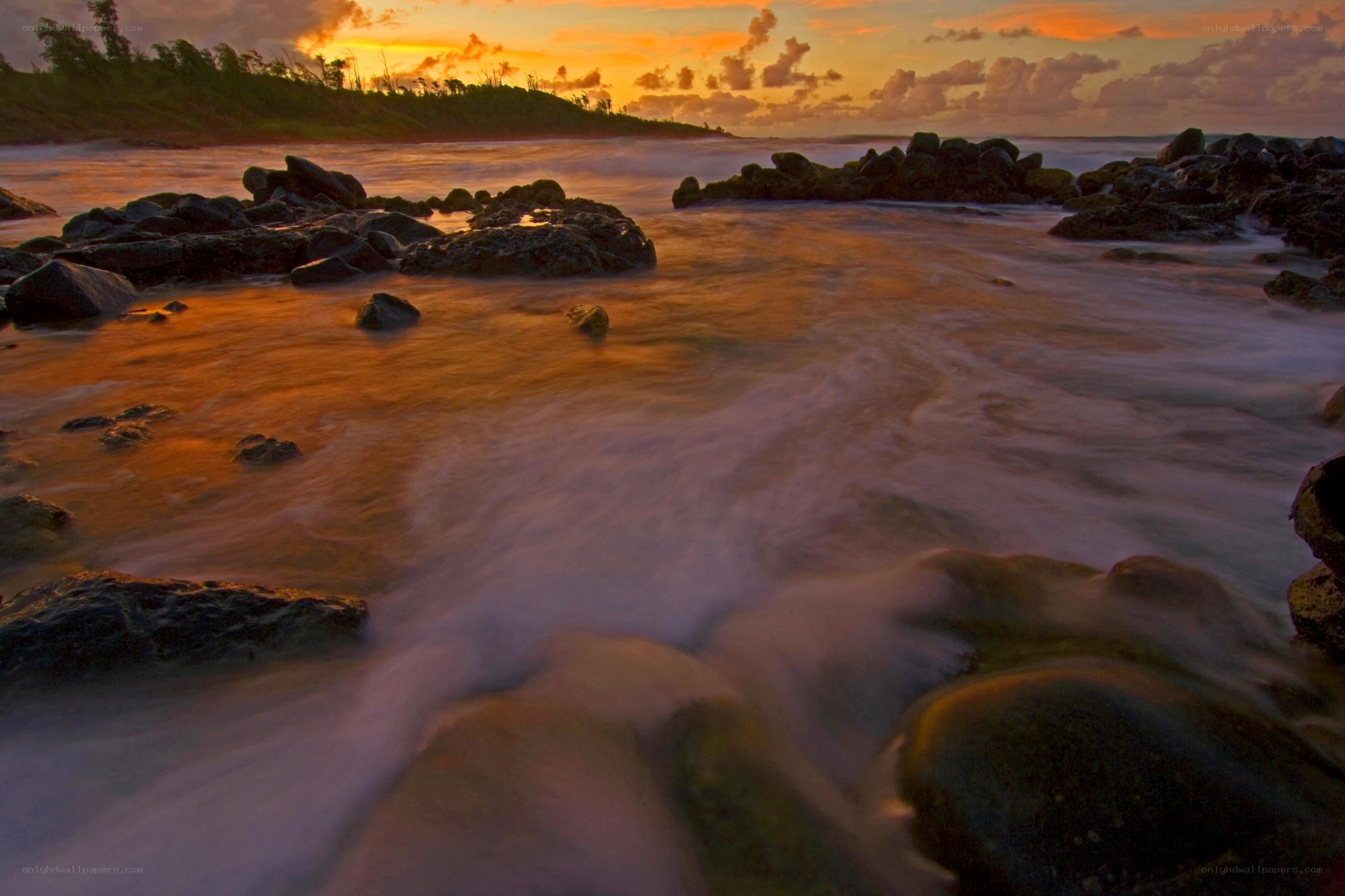 Sunset at rocky beach
