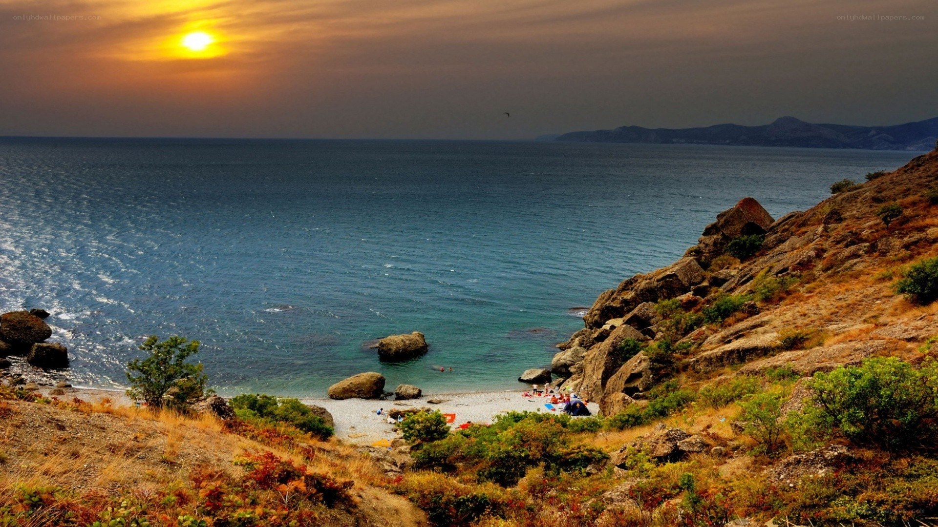 Sunset at rocky beach cove