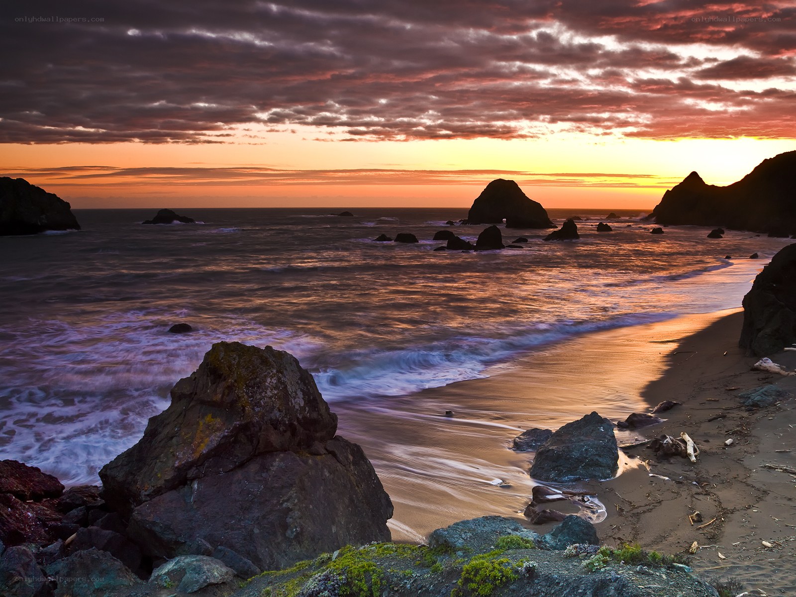 Sunset at rocky coastal beach